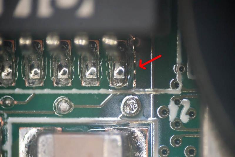 circuit board with a red arrow pointing out a vaporized trace