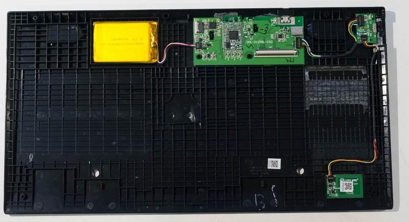 the bottom half of the case of the opened keyboard shwing the battery,
main board, and NFC pairing board