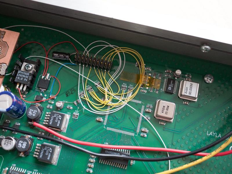 close-up of the header for the microcontroller board with wires going
to the lines for controlling the input gains