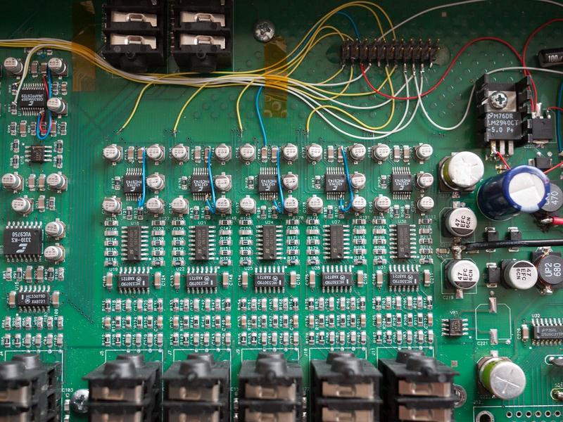 close-up of the D/A section of the main board showing detail of wires
added to configure the mode of the converters and route digital audio
to the glued-on header
